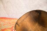 Interior view of the vintage wooden African bowl showing crack repairs and aged patina.