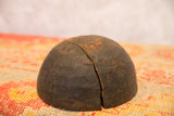 Primitive dark wood bowl with a prominent vertical crack and visible hand-carved texture.