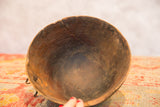Aged interior of the vintage African wooden bowl, displaying visible cracks and dark wood.