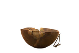 Primitive hand-carved vintage African wooden bowl with brass repairs, rich brown patina.