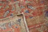 Distressed Oushak rug pile showing wear to knot heads, foundation, and intact selvage.