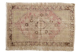 Vintage Distressed Oushak rug with faded pink diamond medallion on an ivory field. 2'9