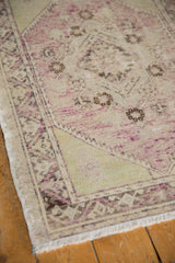 Distressed Vintage Oushak rug border featuring even wear, pale mauve, and sea foam green.
