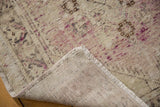 Distressed vintage Oushak rug corner displaying even pile wear, faint foundation, intact selvage, and fringe.
