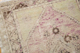 Distressed Oushak rug pile texture showing even wear, faint foundation, and pale mauve.