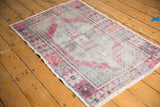 Distressed Oushak rug with mostly even wear, featuring blush, mint, and silver tones.