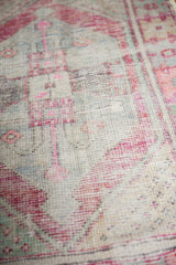 Distressed vintage Oushak rug texture, showing blush pink hues and exposed beige foundation.