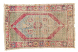 Distressed vintage Oushak rug, faded aubergine medallion, blue field, green spandrels, low pile.