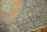 Distressed vintage Oushak rug texture, showing white knots, sandalwood, oxidized silver, and fringe.