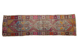 Distressed vintage Oushak runner with an elongated diamond medallion and playful multi-colored border, 2'7