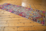 Vibrant, playful colors and distressed texture of the Oushak runner's central design.