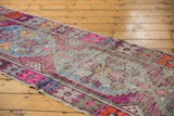 Vibrant distressed texture and exposed knot heads of a vintage Oushak rug runner.