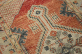 Distressed hand-knotted Oushak rug: brick red, ivory, charcoal geometric stepped patterns.