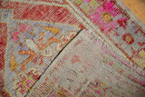 Folded vintage Oushak rug showing plain-woven interior and secure original selvages.