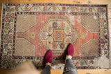 Distressed Oushak rug with hexagonal medallion, showcasing worn pile in apricot, ivory, and silver.