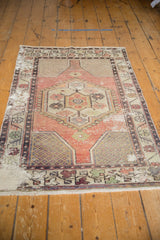 Distressed vintage Oushak rug showcasing hexagonal medallion, intricate vinery, apricot mauve, and ivory tones.