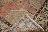 Distressed apricot mauve and ivory Oushak corner revealing hand-knotted foundation and fringe.