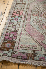 Distressed pile texture and faded blush, mint, ivory tones on vintage Oushak runner.