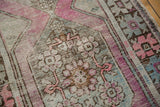 Distressed Oushak runner, showing worn pile, visible foundation, and muted rose, mint, silver hues.