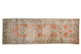 Vintage Distressed Oushak runner, apricot field with stepped medallions, decorative wear.