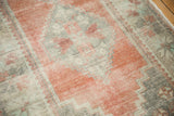 Vintage distressed Oushak rug runner with mostly even wear, revealing soft terra cotta, ivory, and charcoal tones.
