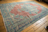 Vintage Distressed Oushak rug corner, showing brick red field, royal blue vine border.