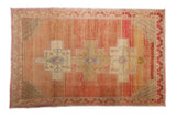 Distressed Vintage Oushak rug, triple medallion design with abrashed blush and raspberry tones.