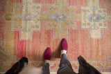 Distressed vintage Oushak rug, blush and sand abrashed field with primitive geometric motifs.