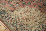 Distressed Oushak carpet corner with blush, charcoal, ivory classic Usak pattern.