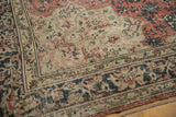 Distressed vintage Oushak rug detail showing worn blush rose, charcoal patterns, and visible foundation.
