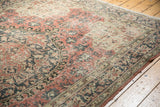 Distressed vintage Oushak rug with faded blush rose, charcoal, and ivory arabesque motifs.
