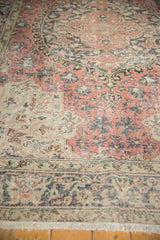 Distressed Oushak carpet pile shows blush rose, charcoal, ivory, and visible foundation.