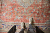 Vintage distressed Oushak carpet with faded red field and royal blue scrolling vinery.