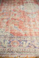 Distressed Oushak carpet pile, mostly even wear on knot heads, faded red, ivory, blue.