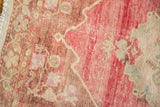 Distressed vintage Oushak runner, showing vivid bubble gum pink abrash and intact selvage.
