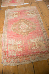 Distressed low pile and fringe on this vintage blush Oushak runner's end.