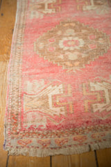 Distressed Oushak runner detail: low pile blush, ivory geometric pattern and fringe.