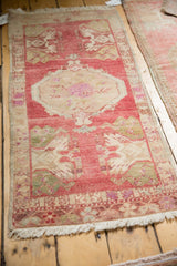 Distressed Oushak runner, raspberry red field, ivory stepped medallion, botanical corner plants.