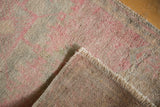 Vintage Oushak rug: distressed low pile, natural fringe, hand-knotted underside.