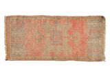 Distressed Oushak rug mat featuring faded pink, silver, and saffron serrated medallion.