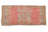 Distressed vintage Oushak rug runner featuring a faded pink medallion and soft silver-grey tones.