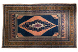 Vintage Oushak carpet with concentric apricot and navy stepped medallion, bronze borders, 6'6