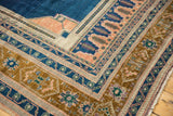 Corner view of vintage Oushak carpet, intricate borders in apricot, bronze, and dark navy blue.