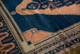 Stepped apricot and dark navy blue geometric pattern on a vintage Oushak carpet.