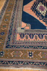 Multi-layered border design of vintage Oushak rug in apricot, navy, and bronze.