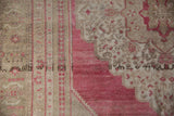 Low pile texture of a vintage Oushak's raspberry red and beige geometric border.