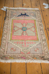 Distressed Oushak rug, lower right with blush, oxidized silver, teal quatrefoil motif.