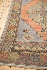 Distressed Oushak runner border, with stepped motifs and even wear in terra cotta and slate.