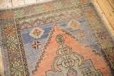Vintage Oushak rug detail: terra cotta stepped spandrel and pale blue field with abrashes.
