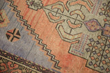Distressed Oushak rug detail with stepped spandrel, apricot and sand plant motifs, pale blue.